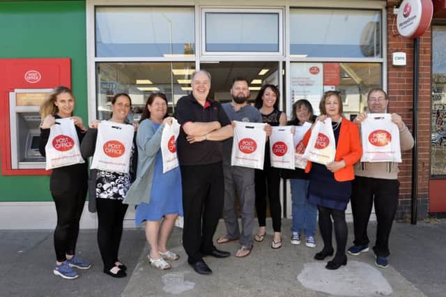 Paul Money is the new postmaster at 326 Seaside, Eastbourne. Pictured here with local business people (Photo by Jon Rigby) SUS-190515-131056008