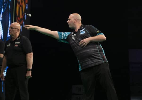 Rob Cross at the oche against Mensur Suljovic in Sheffield last week. Picture courtesy Lawrence Lustig/PDC