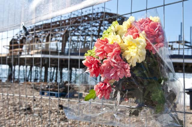 Flowers left at the pier as a tribute to Stephen Penrice SUS-140821-142424001
