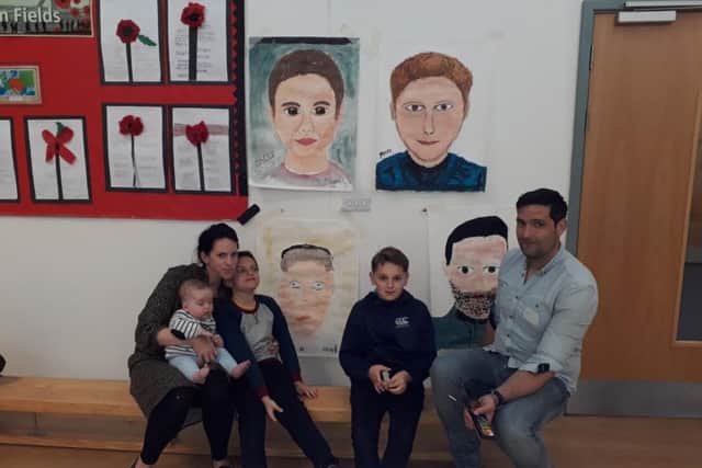 The Sinclair family with their portraits