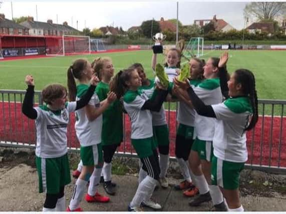 The under-12 girls with the cup