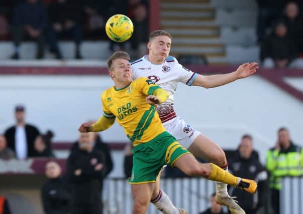 Adam Lovatt goes up for a header during Hastings United's play-off semi-final defeat by Ashford United. Picture courtesy Scott White