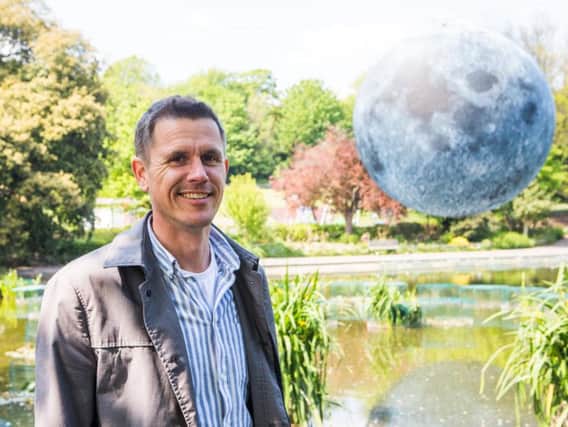 Luke Jerram with his Museum of the Moon (Credit: Summer Dean/Brighton Festival)