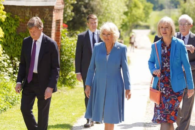 Radiant in blue ... the Duchess of Cornwall arrives at Charleston