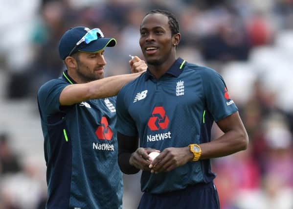 NOTTINGHAM, ENGLAND - MAY 17: Mark Wood of England pulls a label from Jofra Archer's shirt during the 4th One Day International between England and Pakistan at Trent Bridge on May 17, 2019 in Nottingham, England. (Photo by Gareth Copley/Getty Images) 775341612
