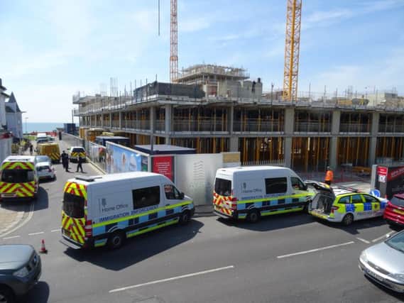 Immigration officers and the police are outside the Bayside Apartments construction site in Brighton Road, Worthing