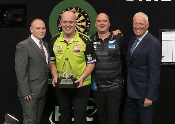 Rob Cross (second-right) and Michael van Gerwen (second-left) at the presentation ceremony after the final. Picture courtesy Lawrence Lustig/PDC