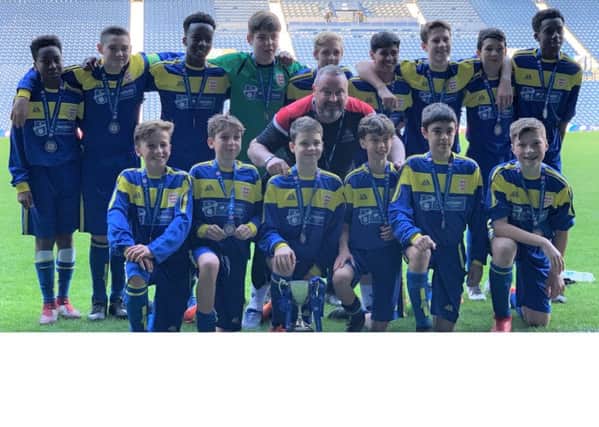 The Claremont School under-13 boys' football team with the trophy after its 7-0 victory at West Bromwich Albion FC