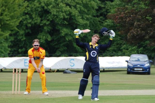 Harry Clark celebrates his hundred. Picture by David Reid