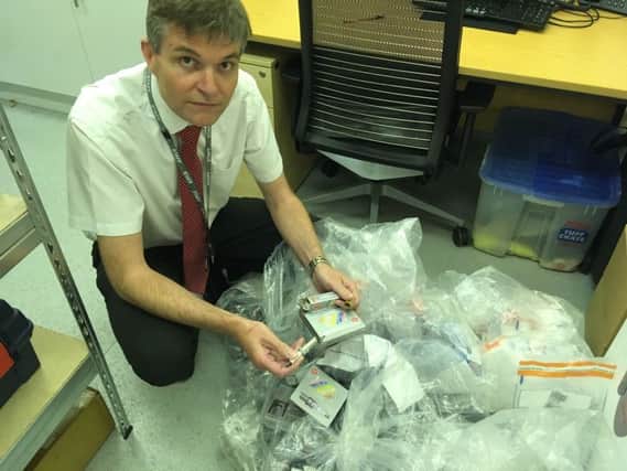 Richard Strawson with some of the seized counterfeit parts SUS-190530-110210001