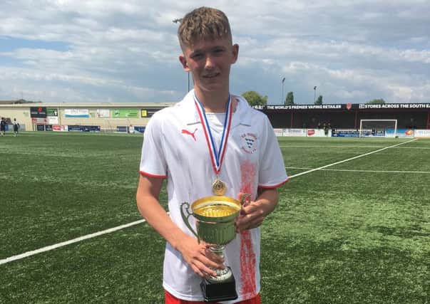 Harry Simmons clutches the South of England Croydon Challenge Trophy, won by the South East Sussex under-16 boys' football team