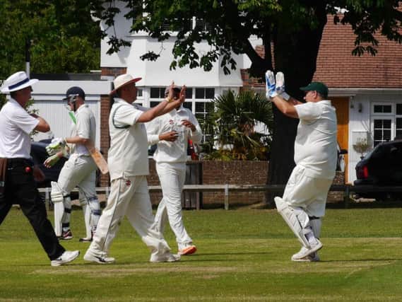 Simon Shivnarain and Kevin Chamberlain celebrate a wicket. Picture by Peter Chapman