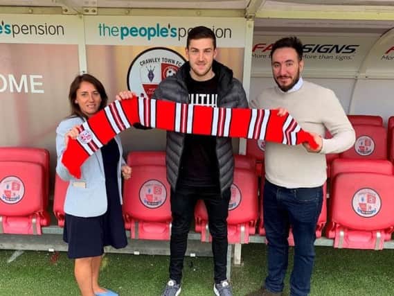Crawley Town new signing Ashley Nadesan with operations director Kelly Derham and director of football Selim Gaygusuz. Picture courtesy of Crawley Town