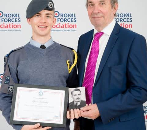 Cadet Corporal Joe Stevens and his father Keith Stevens, with Joes Flying Scholarship and a photograph of Keiths father, Spitfire pilot Cyril Steven SUS-190406-100528001