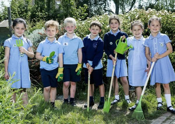 East Preston Infants School pupils Hollie, Arthur,Charlie,Thomas,Serena, Tallulah and Lilly with tools donated by CALA Homes
