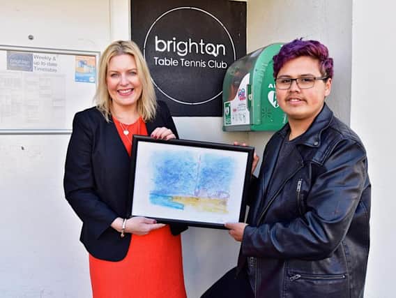 Sports minister Mims Davies receives a painting by BTTC member Tihami Pillant (Credit: Alexis Maryon)