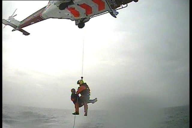 One of the men being winched to safety.