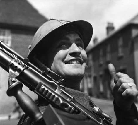 6th June 1944:  A British soldier, encamped in a small English village, gives the thumbs-up as he awaits his orders for D-Day.  (Photo by Fox Photos/Getty Images) PPP-190506-103143003