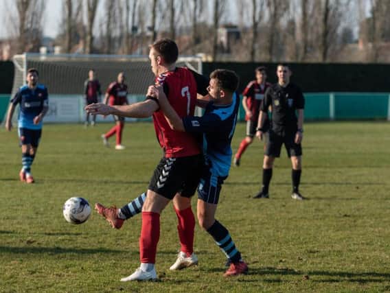 Jack Breed - in blue - battles for the ball in Portchester's visit to Fareham last season