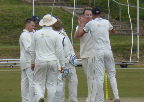 Hastings Priory Cricket Club celebrates its third wicket against Burgess Hill. Picture by Simon Newstead