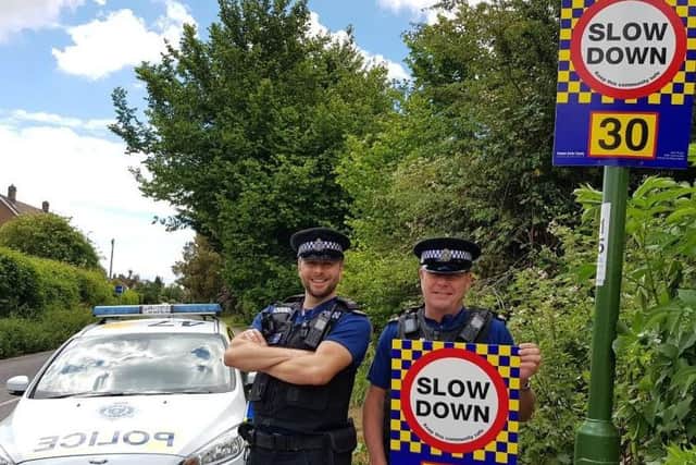 Police with the new signs in Bosham. Photo: Chichester Police/Twitter