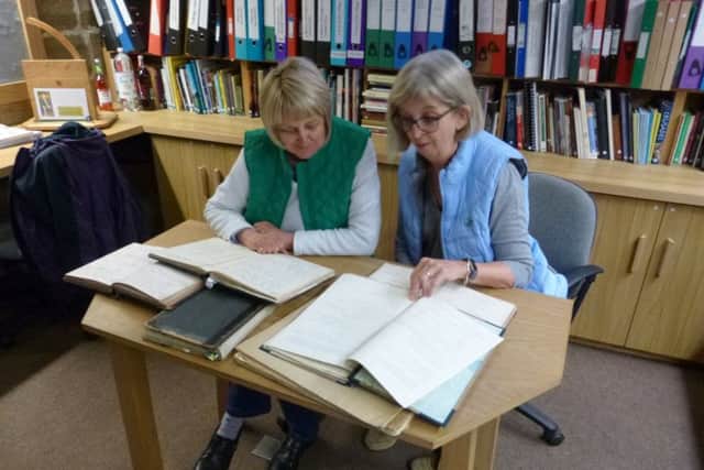 Jane Raistrick, left, and Jane Scott poring over the school log books