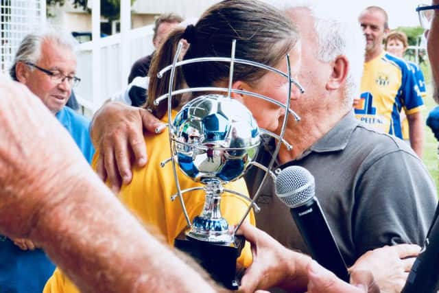 Margaret Blurton, captain of the Old Bexhillians walking football tournament team, receives the trophy and congratulations from the chairman of the Aulnay Football Club