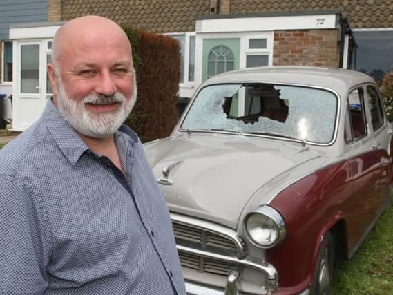 Joe Foxwell from Worthing with his vintage car, which was vandalised. Picture: Derek Martin