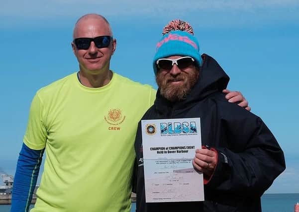 Paul Harris (right) receives his certificate for completing the British Long Distance Swimming Association (BLDSA) Champion of Champions Swim
