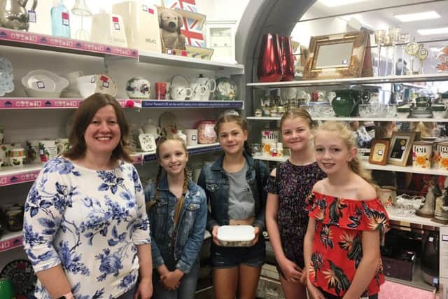 The E Girls, Holly Slater, Isabella Skelton-Edmunds, Sadie Maling and Amelia-Rose Thomas with Donna Hall at the Cancer Research UK charity shop in Rustington