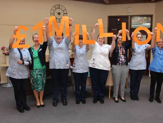 Staff at St Catherine's Hospice celebrate reaching the 1 million mark