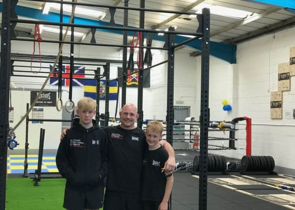 Daz Dugan stands proud at opening of gym with sons Troy and Neo Dugan