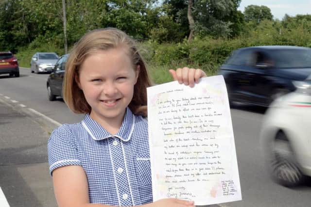 Daisy Jenkins, 10, with the colourful letter she wrote in Ford Road, Arundel
