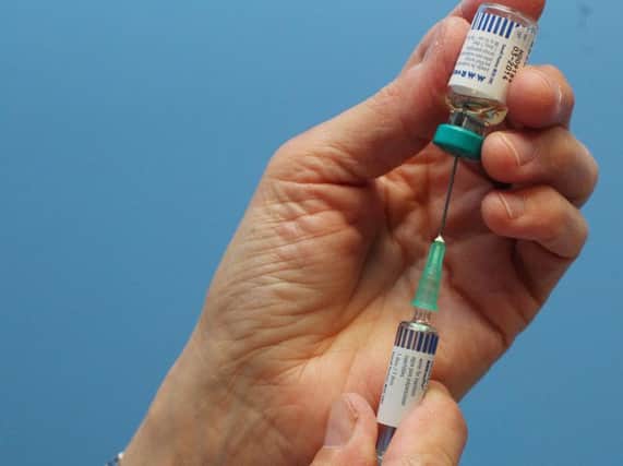 A nurse uses a syringe to prepare an injection of the combined Measles Mumps and Rubella (MMR) vaccination (Photo credit should read GEOFF CADDICK/AFP/Getty Images)