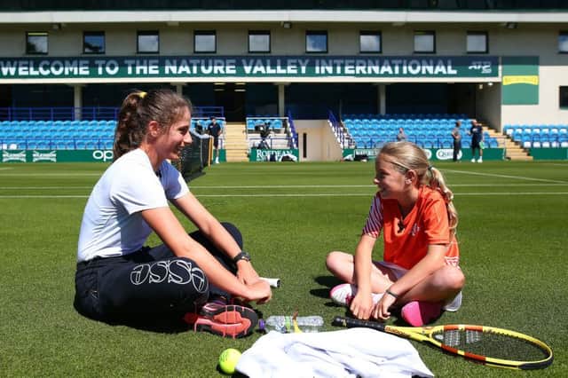 EASTBOURNE, ENGLAND - JUNE 21: Johanna Konta of Great Britain has a surprise hit on court with tennis for kids Ruby prior to the Nature Valley International at Devonshire Park on June 21, 2019 in Eastbourne, United Kingdom. (Photo by Charlie Crowhurst/Getty Images for LTA) *** Local Caption *** Johanna Konta SUS-190622-124523002