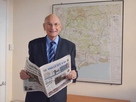Cllr Tony Dignum stood in front of a map of Chichester district
