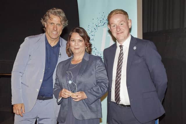 Donna O'Connell receives her award from TV personality John Bishop and  RSPCA deputy chief executive Chris Wainwright SUS-190107-112432001