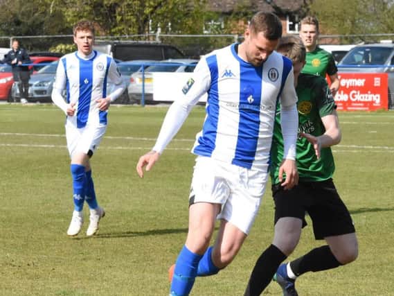 Kenny Pogue (centre) in action for Haywards Heath Town last season. Picture by Grahame Lehkyj
