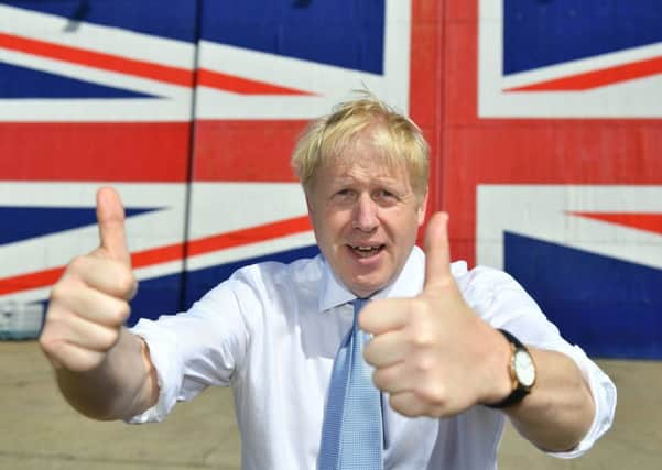 ISLE OF WIGHT, UNITED KINGDOM - JUNE 27: Conservative party leadership contender Boris Johnson poses for a photograph in front of a Union Jack on a wall at the Wight Shipyard Company at Venture Quay during a visit to the Isle of Wight on June 27, 2019 on the Isle of Wight, United Kingdom. Boris Johnson and Jeremy Hunt are the remaining candidates in contention for the Conservative Party Leadership and thus Prime Minister of the UK. Results will be announced on July 23rd 2019. (Photo by Dominic Lipinski - WPA Pool/Getty Images) PPP-190628-105619003