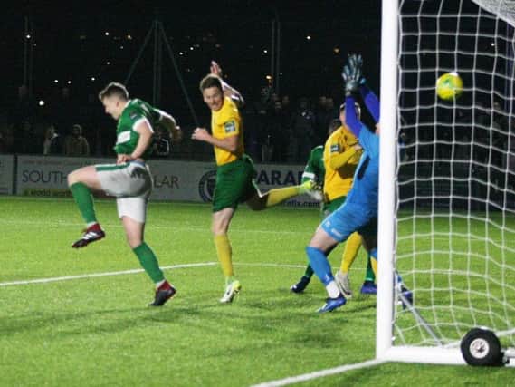 Dylan Merchant heads home Horsham's winner in May's play-off final. Photo by Derek Martin Photography