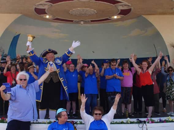 Town crier Bob Smytherman joins The Pines day centres choir on stage at the launch on Friday (June 28)