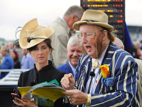 John McCririck and Tanya Stevenson at work in the Goodwood betting ring / Picture by Malcolm Wells