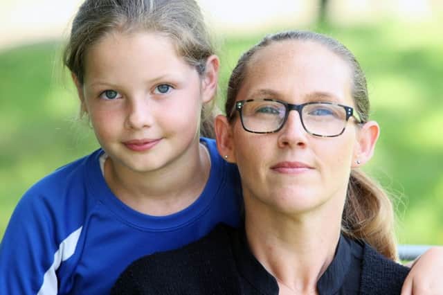 Mum  Kelly O'Brien, pictured  with her daughter Daisy, is worried some parents might not be able to afford a new PE kit being introduced at Millais School.  Photo by Derek Martin Photography. SUS-190207-174125008