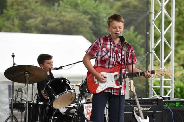 Funday Sunday

Rotary Club of Horsham Funday Sunday.

Pictured are Lightning on the main stage. Band member Sam Holder (10) with brother Ben Holder on drums. 

Horsham Park, Horsham, West Sussex.

Picture: Liz Pearce

07/07/2019

LP190711 SUS-190807-082058008