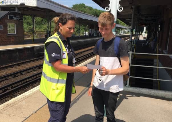 Pulborough Neighbourhood Warden Vanessa Green talking to a local young man at Pulborough Station about the drugs campaign. SUS-190807-171045001
