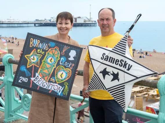 MP for Brighton Caroline Lucas and artistic director of Same Sky John Varah with a copy of the stamp. Photograph: Tony Kershaw/ SWNS