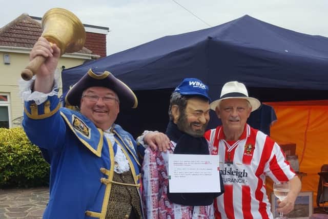 Worthing town crier Bob Smytherman with raffle organiser Will Lefebve and his £50 suit game