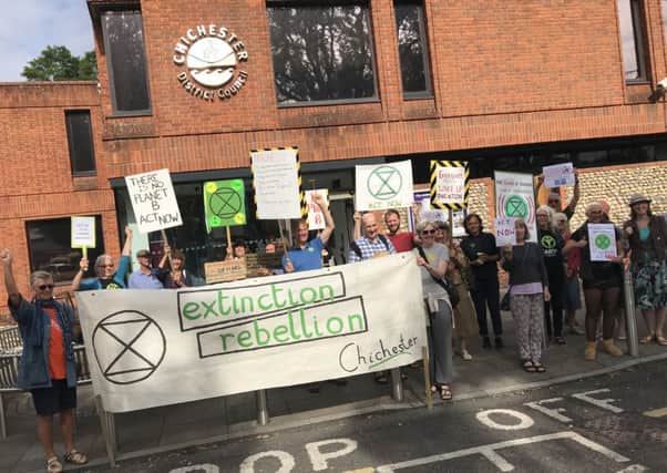 Extinction Rebellion campaigners outside of Chichester District Council this morning