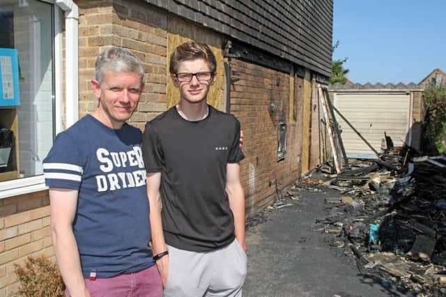 Littlehampton teenager Josh Bruford, 13, praised for saving his neighbours' lives after a fire broke out between their houses in White Horses Way, Littlehampton. Pictured with his dad Graham. Photo by Derek Martin Photography