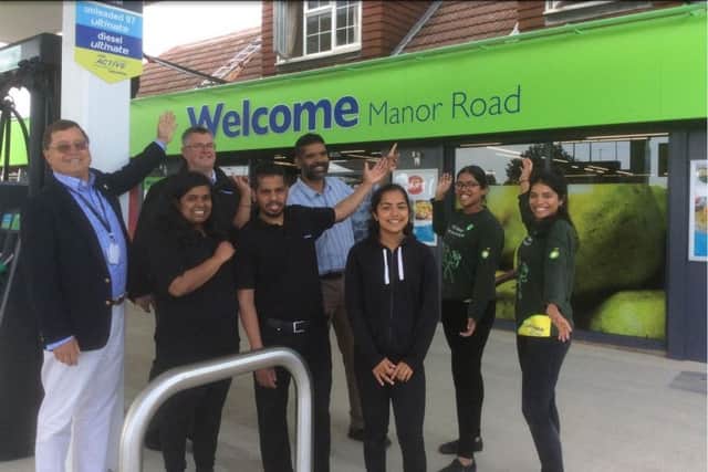 Councillor Carson Albury (left) with Subu Nanthakumar (centre, back row), his three daughters and staff from the Co-op